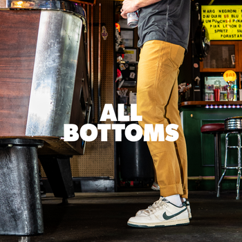 person with brown pants standing next to a pool table with the text "all bottoms" overlay