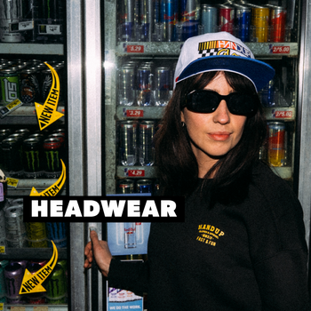 a woman standing in front of a drink cooler wearing sunglasses and a white hat with text overlayed
