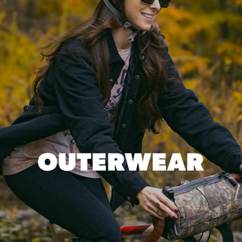 Person holding a jacket with 'Outerwear' text in an autumnal setting