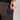 Person wearing dark pants with a pocket, holding a black phone case.