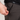 Person adjusting a zipper on dark pants with 'Handup' brand logo.
