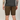 Person wearing brown shorts and a black shirt on a plain background