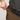 Person wearing a dark gray long-sleeve shirt and brown pants, adjusting the waistband.