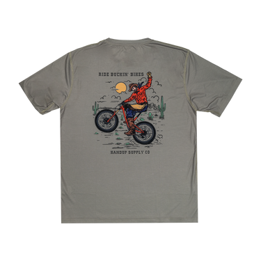Gray t-shirt with a graphic of a person riding a bike and text on the back, on a white background.