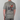 Person wearing a gray t-shirt with a graphic design on the back, featuring a person riding a bike and text.