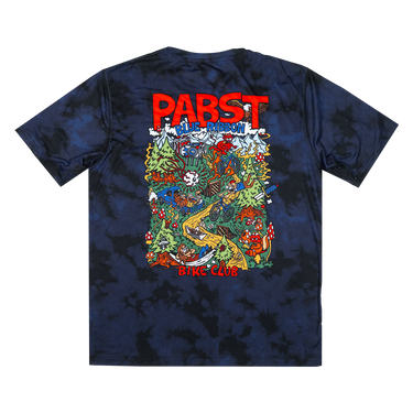 A dark navy blue tie-dye t-shirt with a large, colorful graphic print on the back. The graphic features the text 'PABST' in bold red letters at the top and 'BIKE CLUB' at the bottom, surrounding a detailed multicolor illustration of a psychedelic desert scene with cacti, a yellow dune, and a skull.