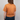 Person wearing an orange t-shirt and blue jeans against a plain background