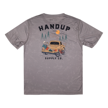 Gray t-shirt with a graphic design on the back featuring a truck and trees, with 'Handup Supply Co.' text.