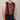 Person wearing a colorful mushroom-patterned cycling bib with 'Vandor' branding on a plain background