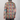 Person wearing a colorful patterned shirt against a plain background