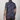 Person wearing a short-sleeve shirt with a colorful pattern on a plain background