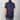 Person wearing a short-sleeve shirt with colorful abstract pattern on a plain background