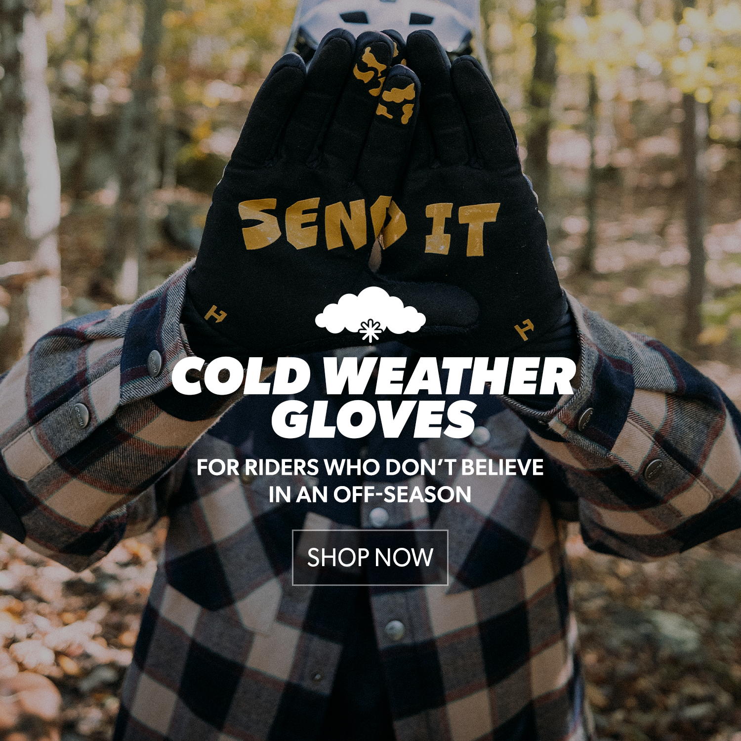 Person wearing black cold weather gloves with 'SEND IT' text, set against a blurred forest background.