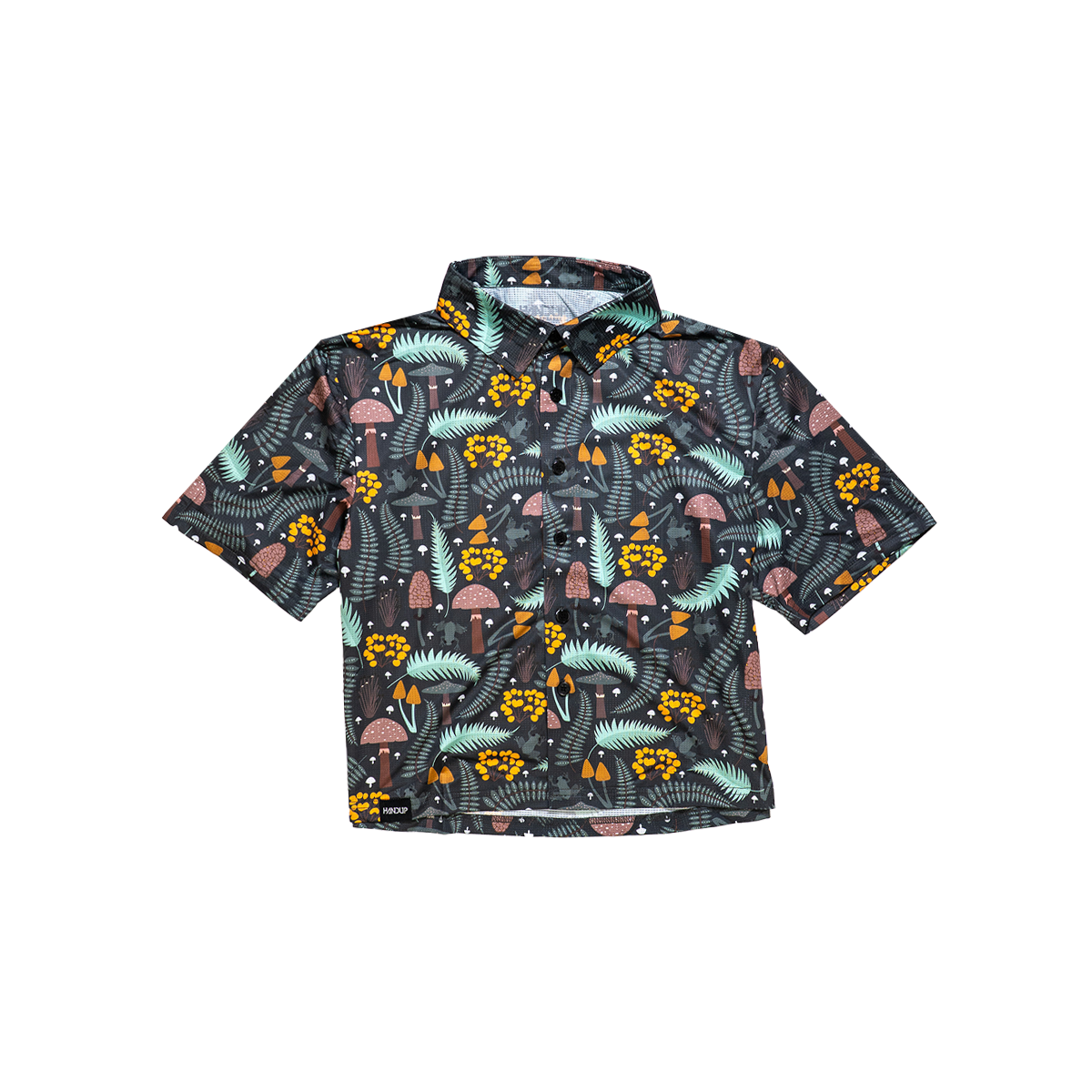 A cropped, button-up shirt with a green floral pattern on a dark background, designed for girls.
