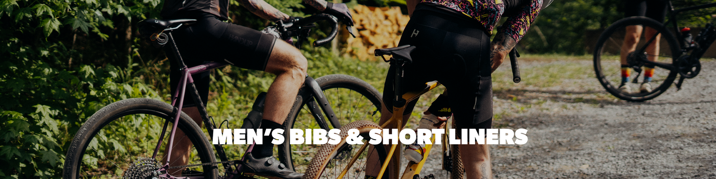 Bicyclists on a gravel path with text overlay 'Men's Bibs & Short Liners'.