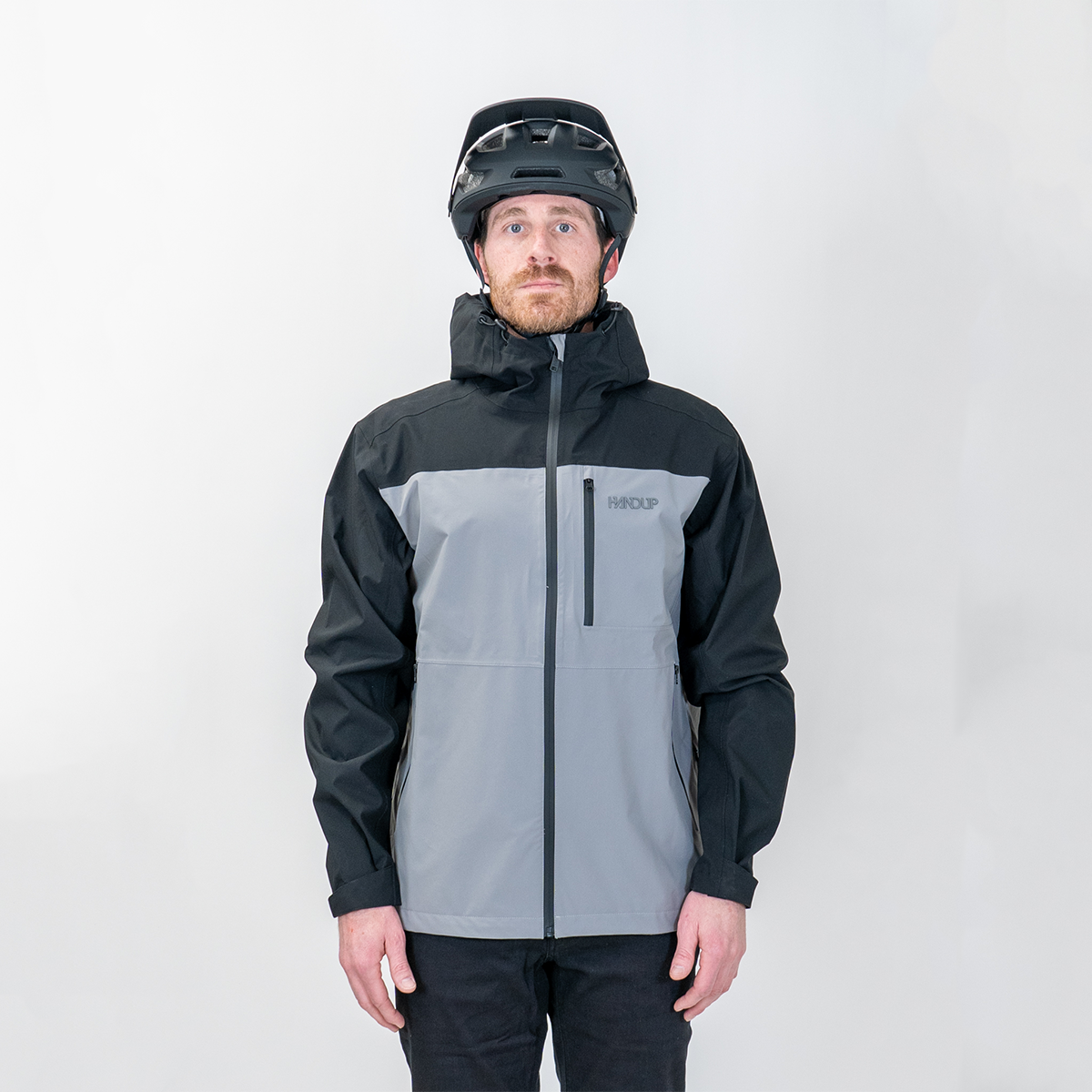 a person wearing a Two-tone black and gray jacket with a helmet on a white background