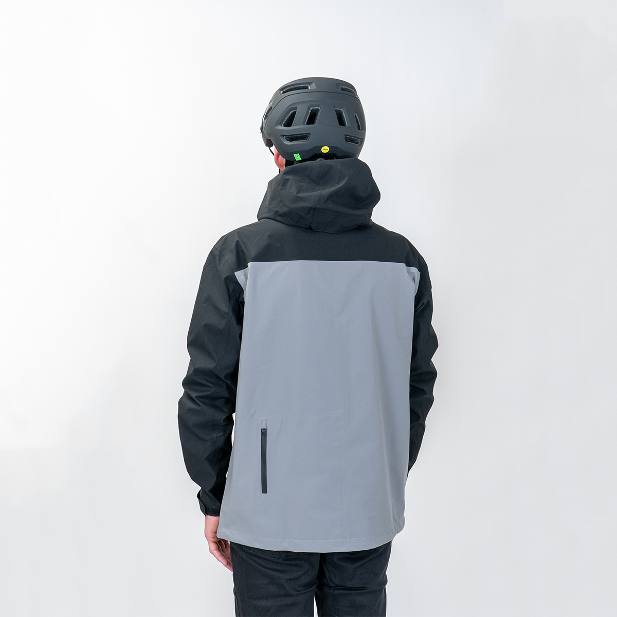 a person wearing a Two-tone black and gray jacket with a helmet on a white background