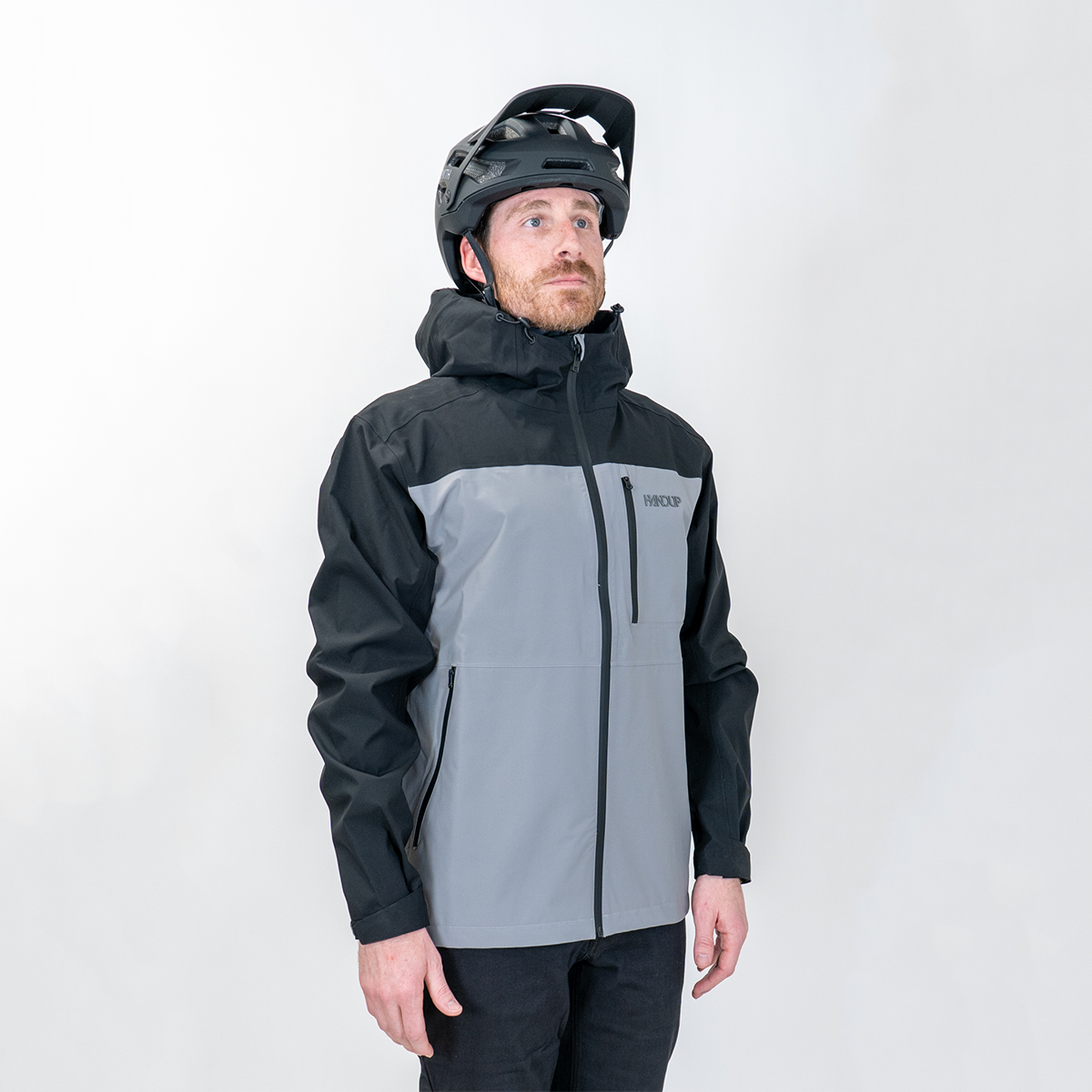 a person wearing a Two-tone black and gray jacket with a helmet on a white background