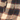 Close-up of a plaid fabric with a zipper, showing texture and pattern details.