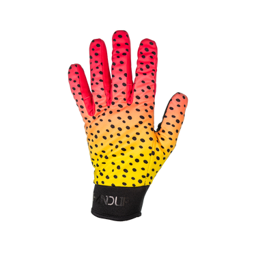 A single athletic glove shown flat against a solid white background. The glove features a vibrant gradient transitioning from red at the fingertips, through orange and yellow on the back of the hand, to black at the wrist.