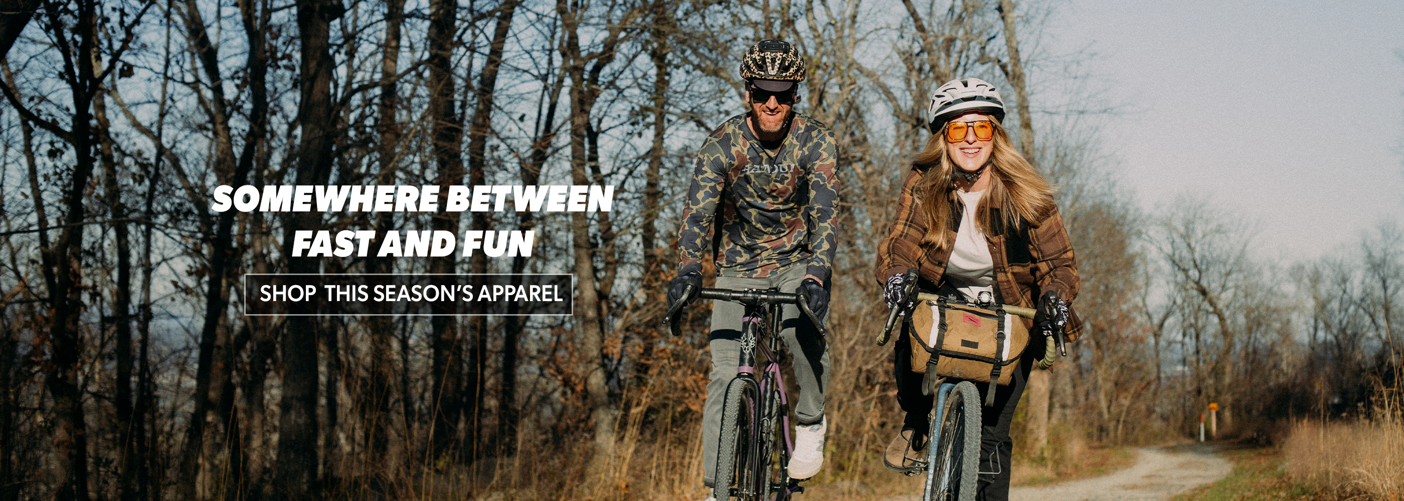 Two people on bicycles in a forest with text overlay about clothing.