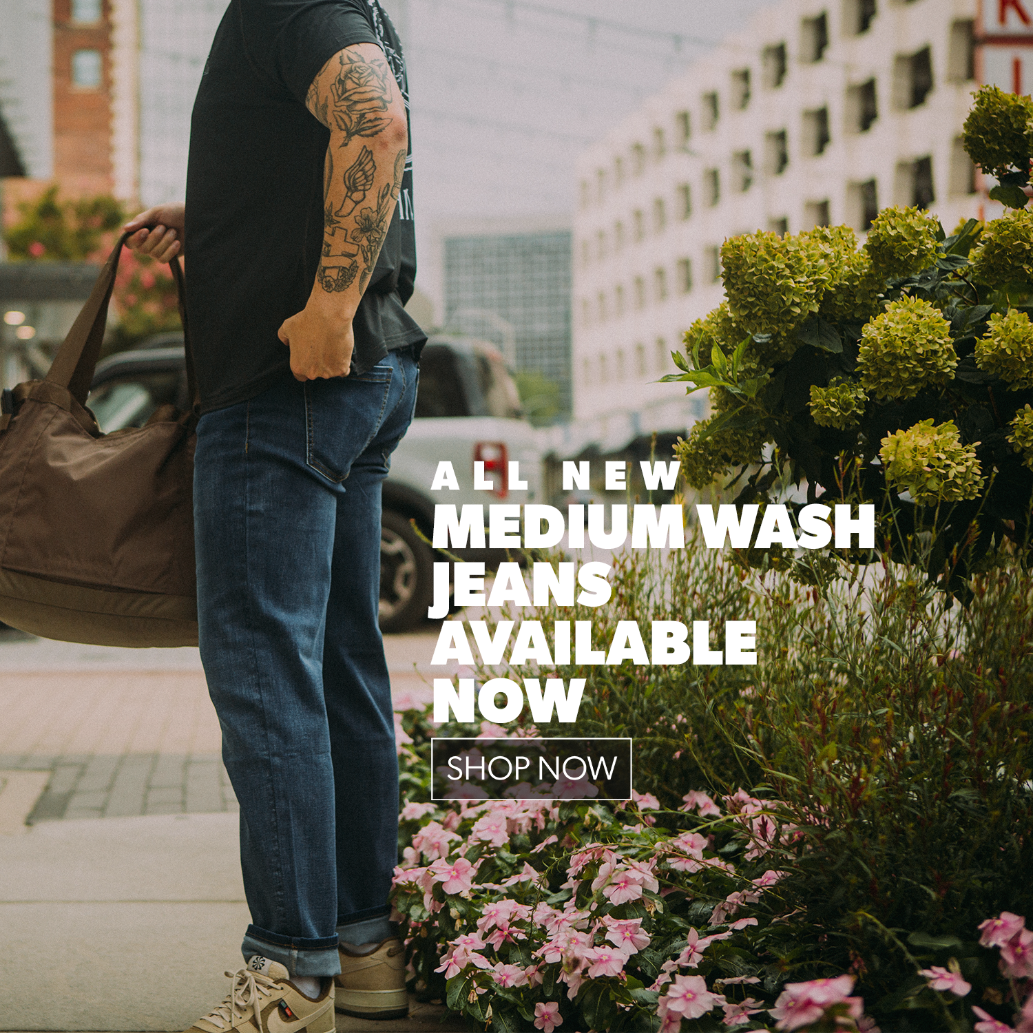 Person wearing medium wash jeans with promotional text overlay on a city street.