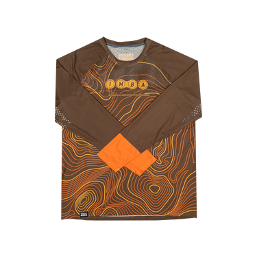 A long-sleeve athletic jersey in brown with an orange and yellow topographic contour line pattern, featuring the letters 'IMBA' across the chest and solid orange cuffs.
