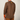 A man viewed from the back wearing a brown long-sleeve athletic shirt with orange accents on the inner cuffs and a small orange 'Create Enhance Project' logo on the upper back, against a light gray studio background.