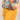 Person wearing a colorful floral shirt and yellow pants with a leopard print pocket detail.