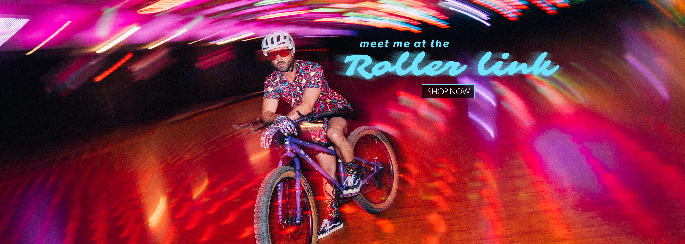 Person on a bicycle with colorful lights and text overlay in a tunnel-like setting