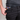 Person wearing black pants with a colorful underwear brand logo visible.