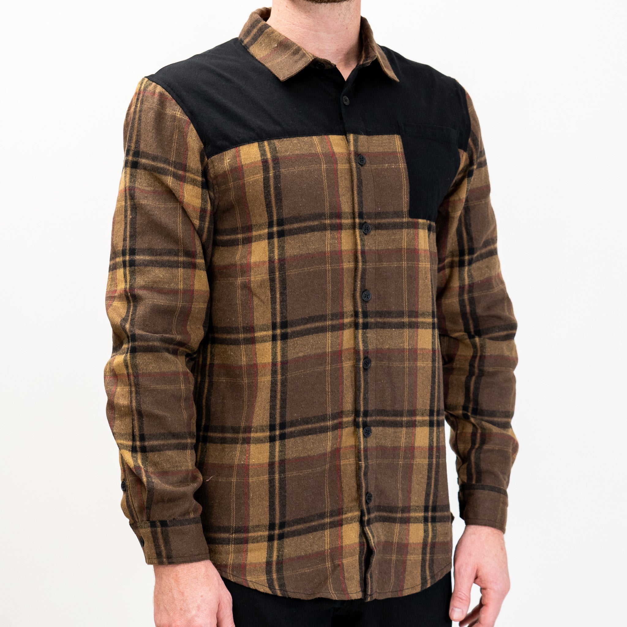 A long-sleeved Flannel Button Up shirt in brown and tan plaid pattern with a solid black panel across the shoulders.