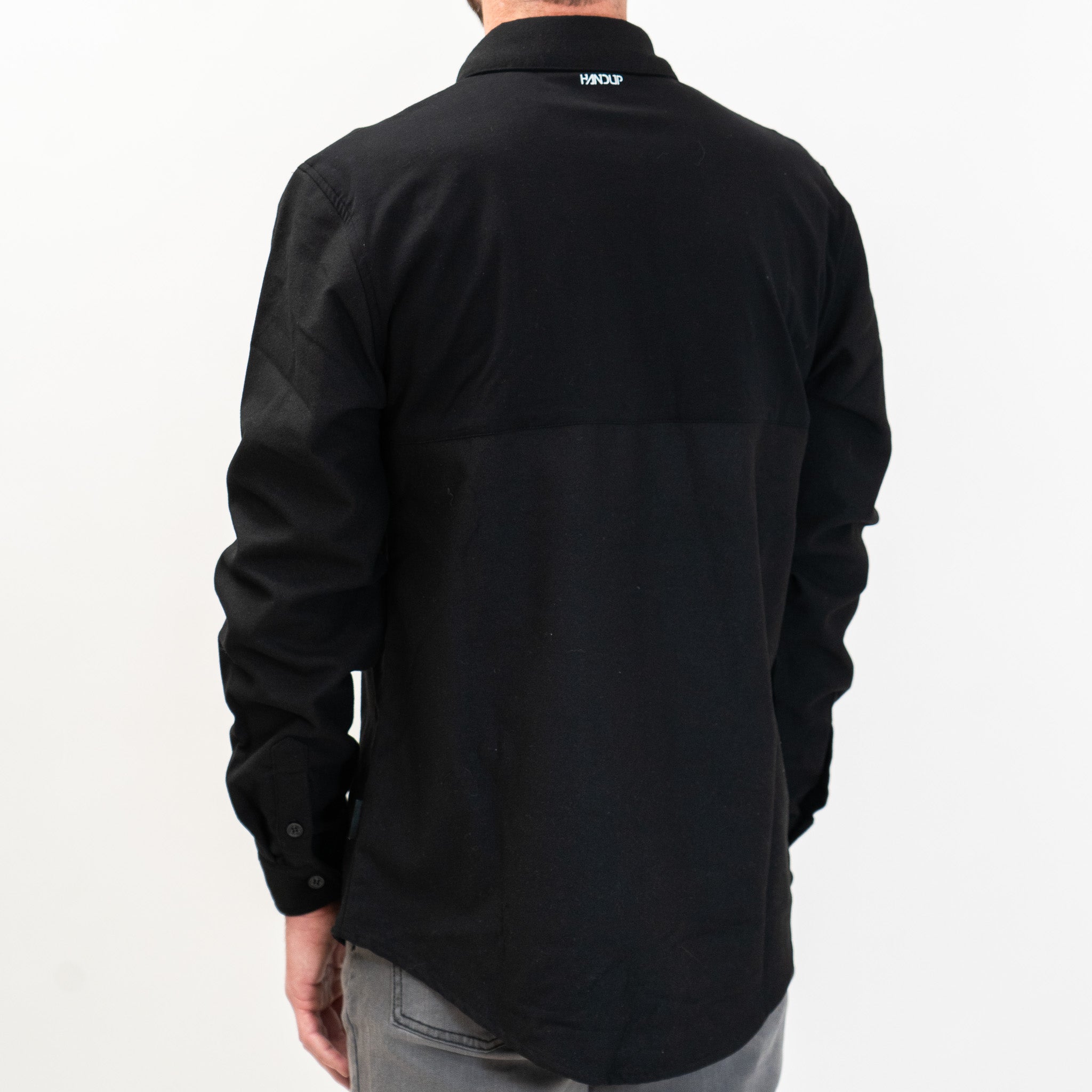 A solid black long-sleeved flannel button-up shirt.