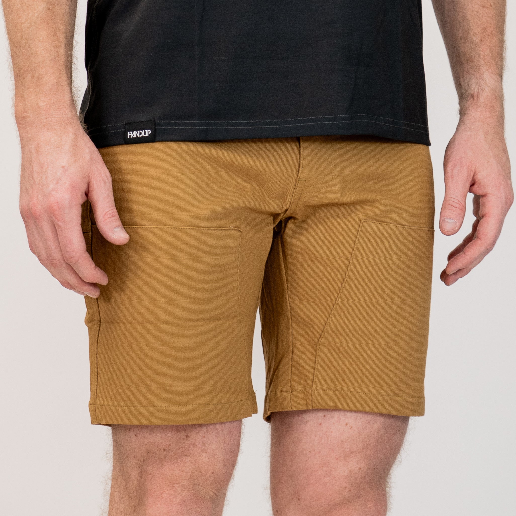 Person wearing tan brown work shorts