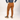 Person wearing brown pants and a blue shirt on a white background