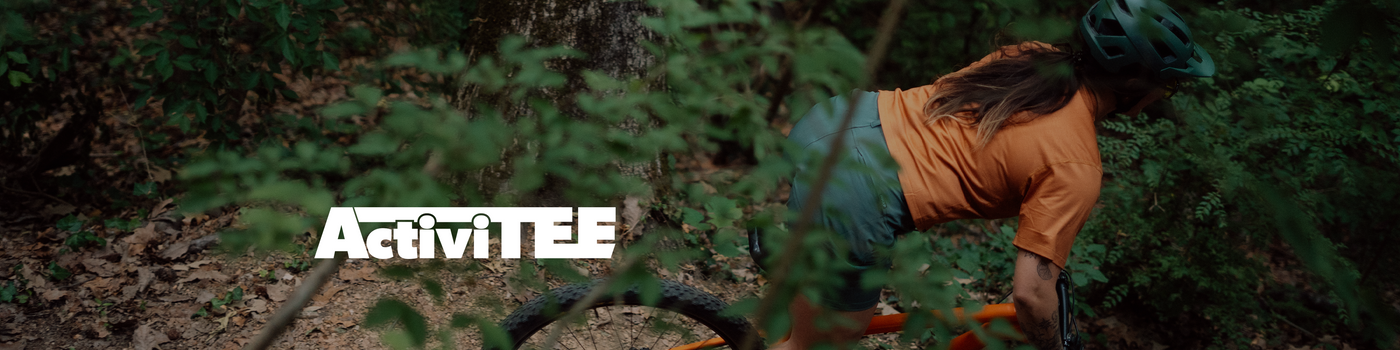 woman riding a mountain bike through trees with the word 'activitee' overlayed