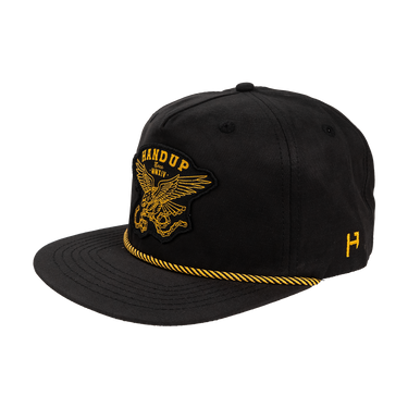 Black cap with yellow embroidered design on a white background
