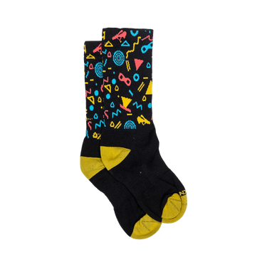 Black socks with colorful geometric patterns and yellow toes and cuffs on a white background