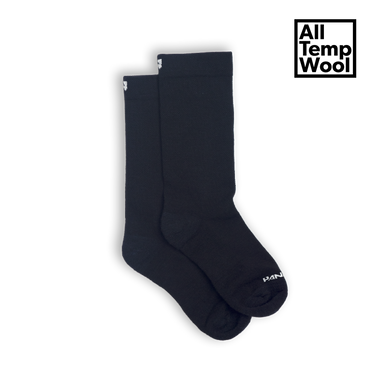 A pair of black wool socks with visible branding on the ankle area.