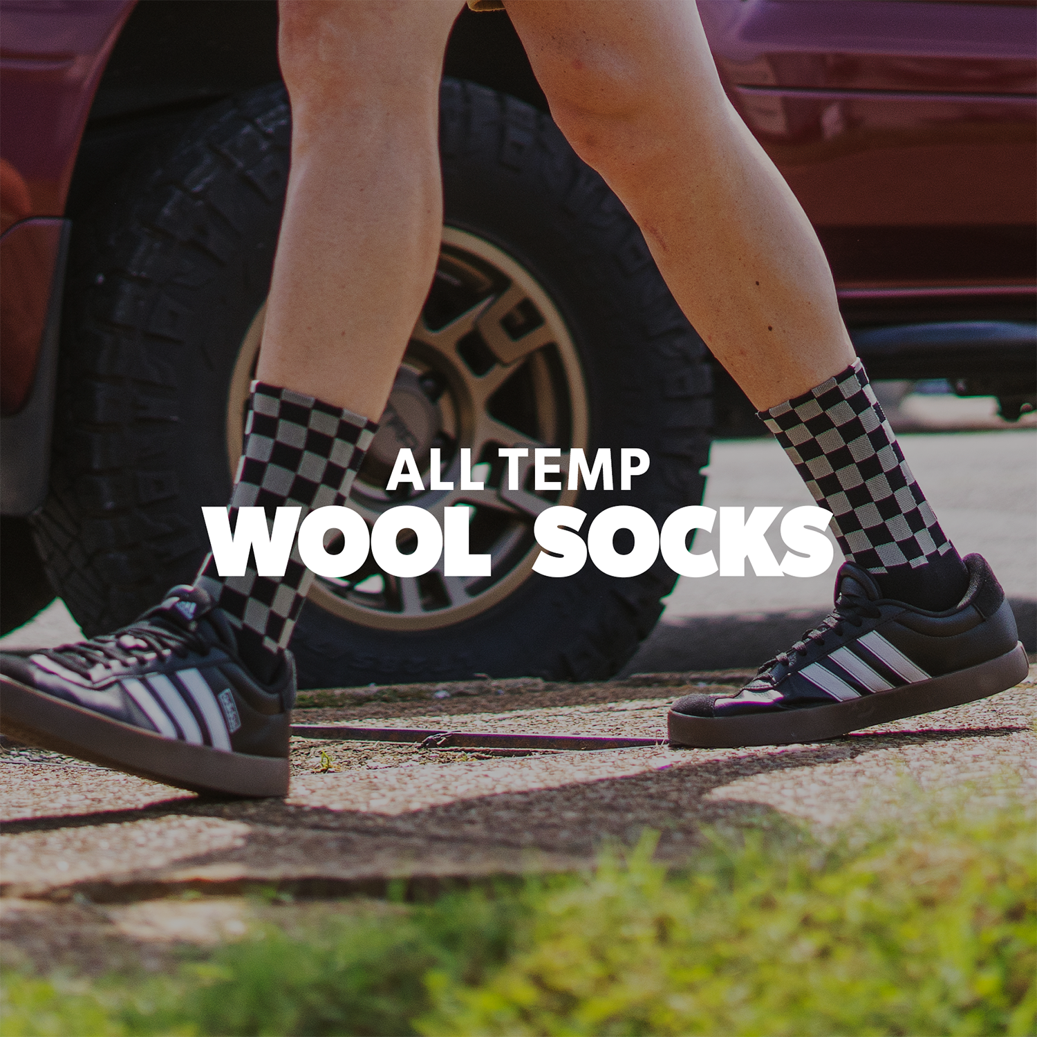 Person wearing checkered socks with text 'All Temp Wool Socks' on a blurred street background