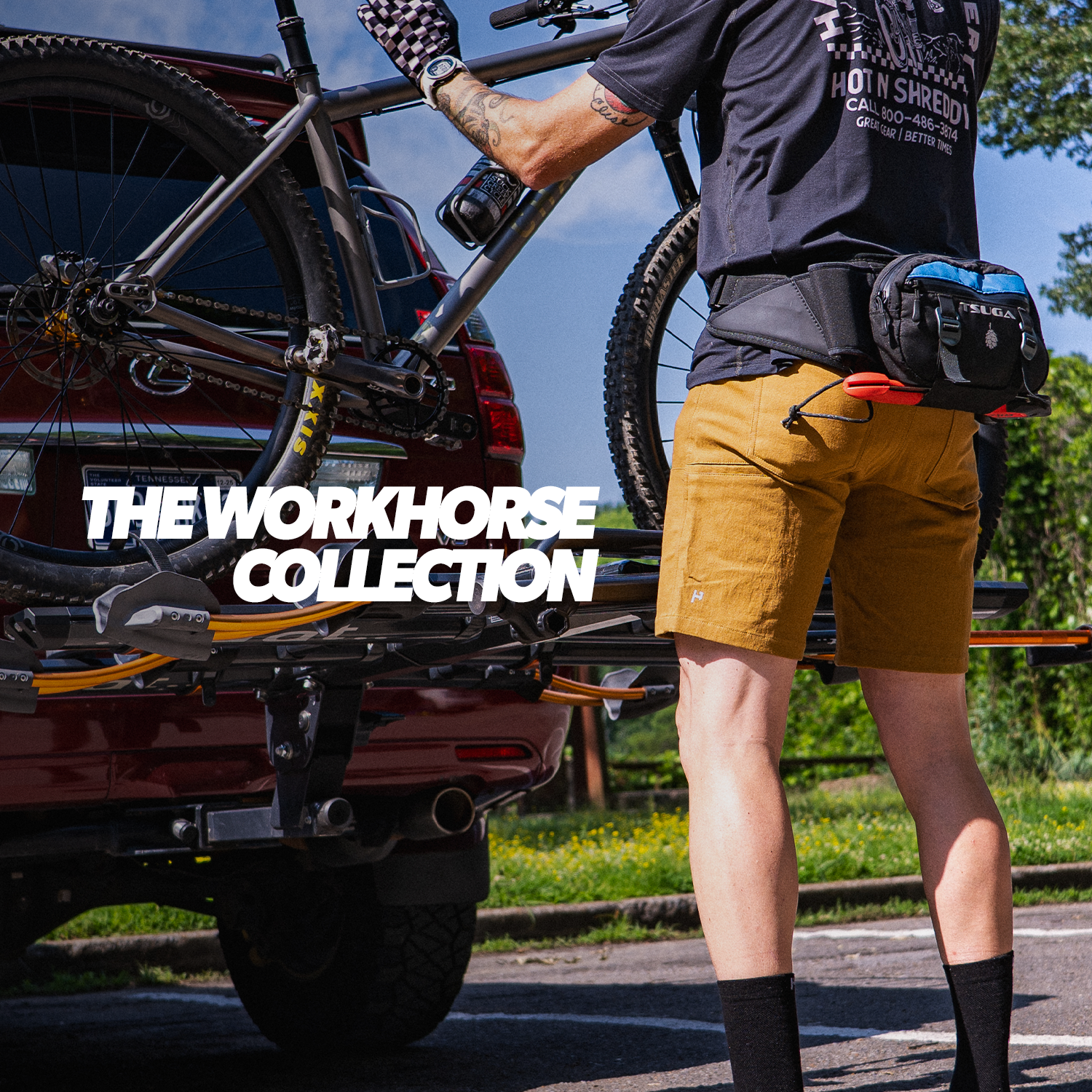 Person lifting a bike off of the back of an SUV including a promotion for the Workhorse Collection.