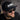 Man wearing a black cap with 'IMBO' logo and sunglasses, against a blurred background