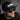 Man wearing a black cap with 'IMBO' logo and sunglasses, against a blurred background