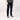 Person wearing black pants and black sneakers on a plain background
