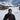 Person standing in a snowy landscape with a mountain in the background