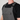 A close-up of a person wearing gray canvas bib overalls over a black t-shirt. The overalls feature adjustable black straps, a buttoned chest pocket, and a large front pocket, with the brand name 'HAND UP' embroidered on the chest.