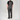 A man viewed from behind wearing dark gray bib overalls over a black t-shirt, standing against a light gray studio background.