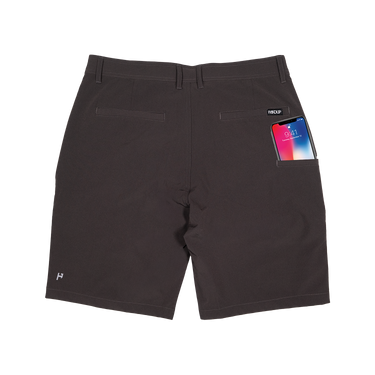 Black shorts with a smartphone in the pocket on a white background