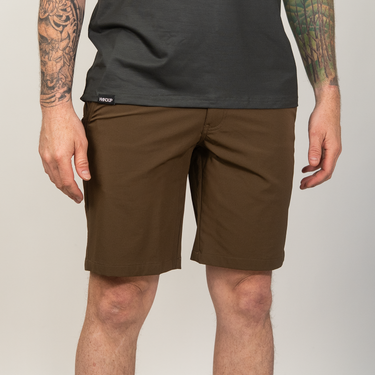 Person wearing brown shorts and a black t-shirt on a plain background