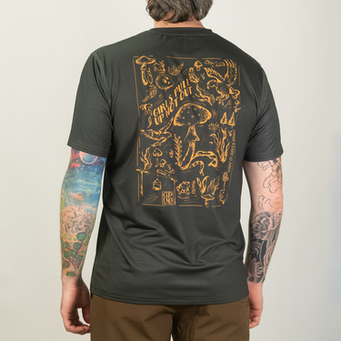 Person wearing a black t-shirt with a gold graphic design on the back, standing against a plain background.